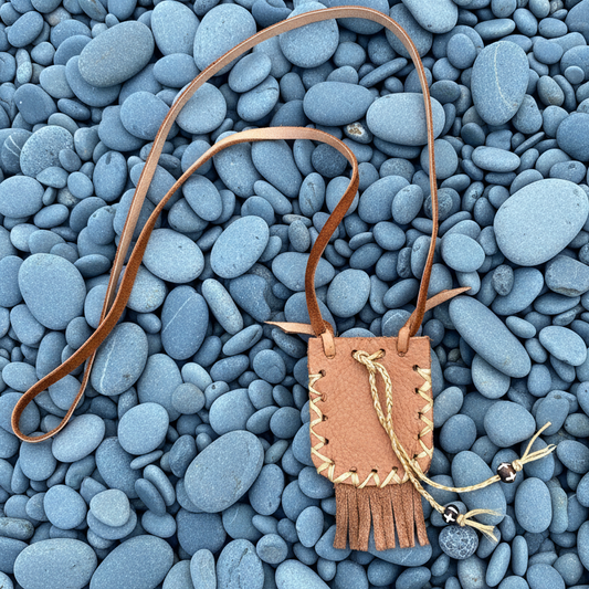 Mojo Hand Pouch | Sienna leather pouch with bone beads on twine drawstrings and a leather necklace.